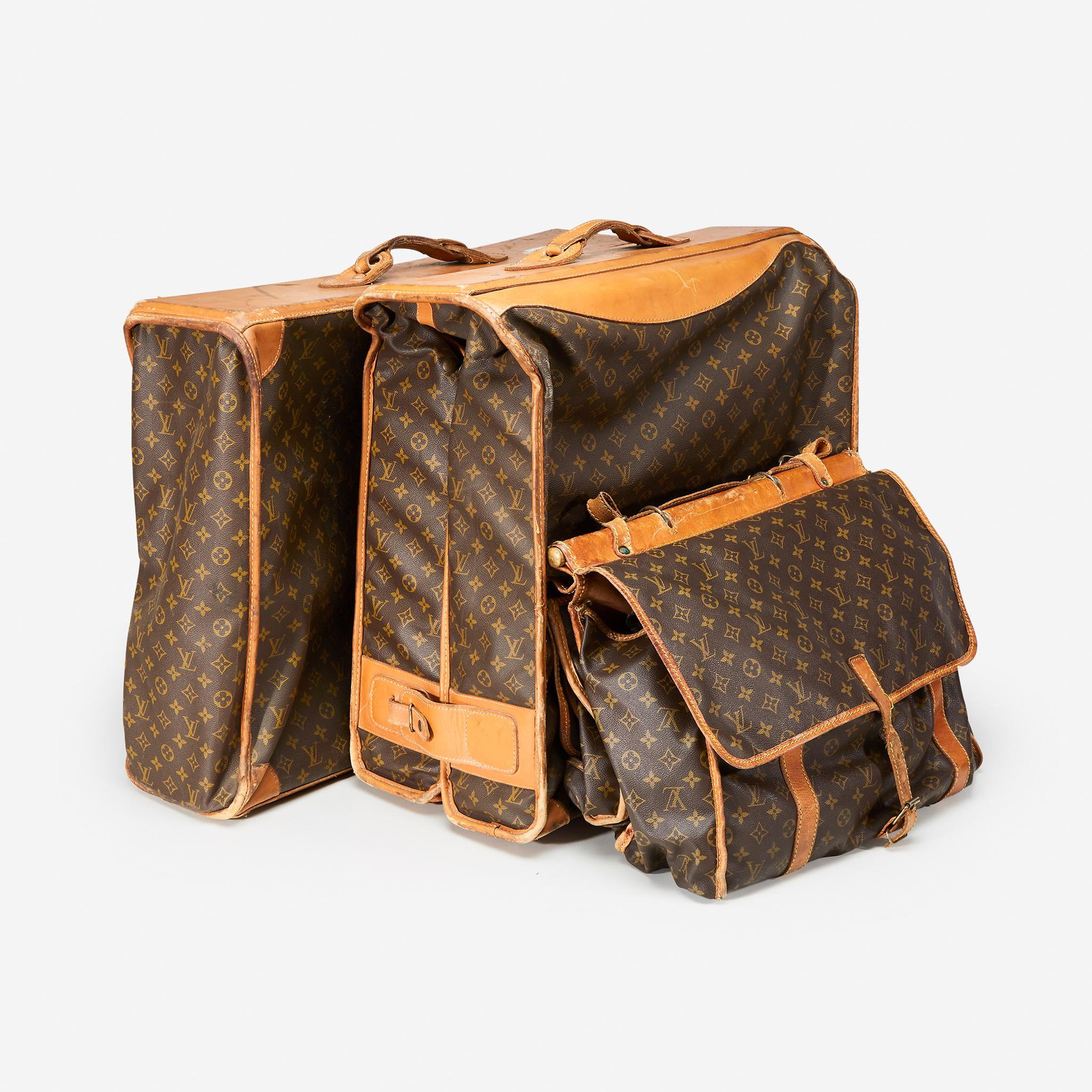 Three pieces of vintage soft side luggage, Louis: Three pieces of vintage soft side luggage, Louis Vuittoncomprised of a monogrammed canvas sac chasse, a monogrammed canvas large garment bag, and a large monogrammed canvas suitcase.Dimensions: 19 x 1