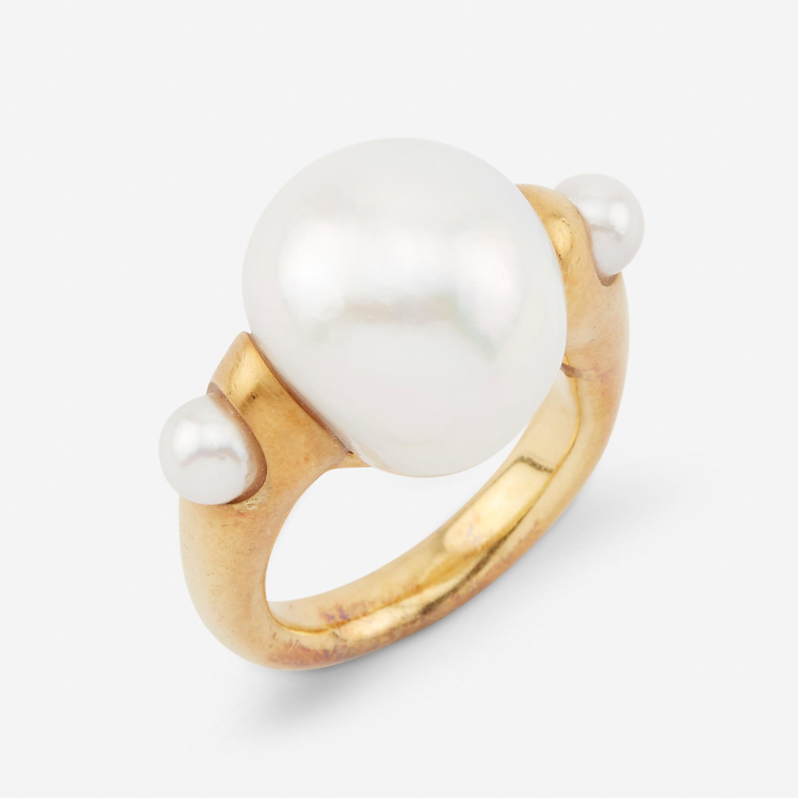 A South Sea cultured pearl and eighteen karat gold: A South Sea cultured pearl and eighteen karat gold ringthe baroque pearl measuring approximately 15.3mm within substantial artisan mount.11.8 dwt.; Size: 5 1/2