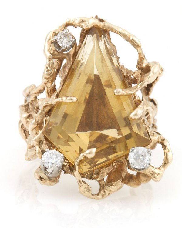 An 18 Karat Yellow Gold, Citrine and Diamond Ring, 12.1: An 18 Karat Yellow Gold, Citrine and Diamond Ring, attributed to Arthur King, in an organic design, with a fancy kite shape step cut citrine measuring approximately 28.00 mm x 17.00 mm and three round
