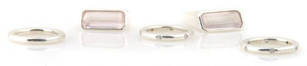 A Group of Sterling Silver Stackable Rings,: A Group of Sterling Silver Stackable Rings, comprised of two stackable rings with pink quartz and three stackable rings with glass stones.