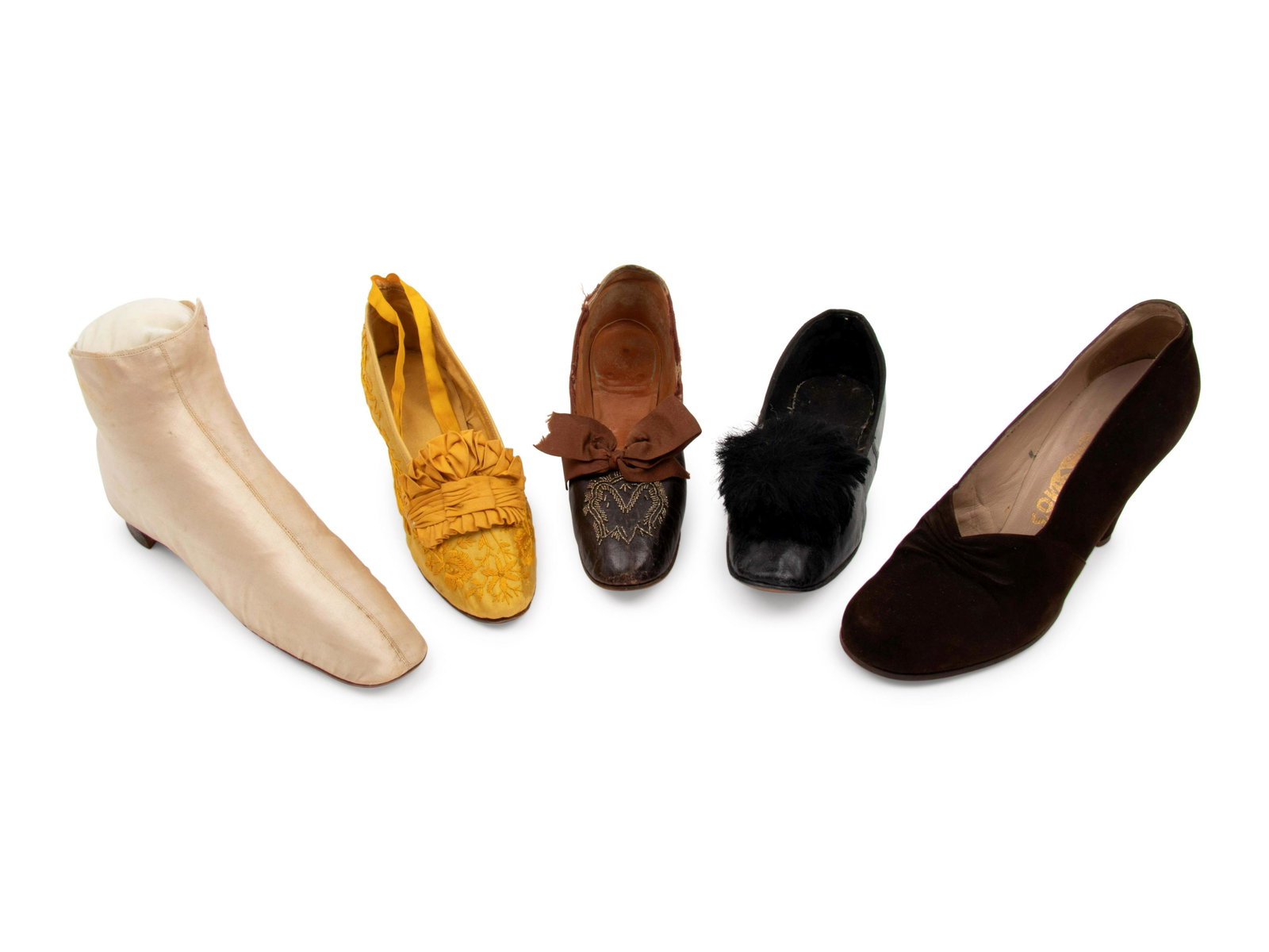 Collection of Nine Pairs of Shoes, c1830s - 1940s: Collection of Nine Pairs of Shoes, c1830s - 1940s This lot includes nine pairs of shoes. THE FIRST Ivory satin boots with cobbled leather soles and side lace up closures. Unlabeled, though there are m
