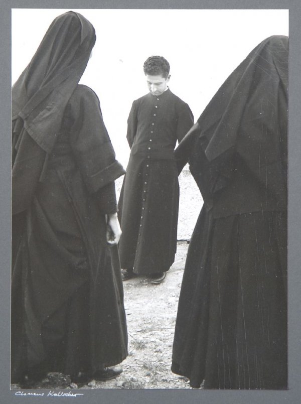 Clemens Kalischer, (German/American, b. 1921), Two Nuns: Clemens Kalischer (German/American, b. 1921) Two Nuns and Priest, Val Stura, Italy, 1963 gelatin silver print signed (on the mount) 9 3/4 x 7 inches.