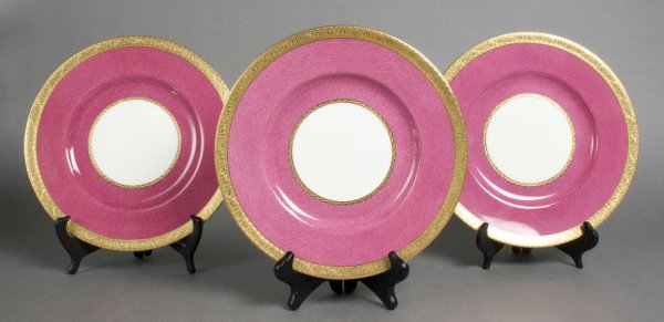 A Group of Eleven Minton Porcelain Plates, Diameter 10 : A Group of Eleven Minton Porcelain Plates, retailed by Tatman, Chicago, having impressed Minton mark to base, each having a fuschia field set within a gilt border. Diameter 10 1/4 inches.