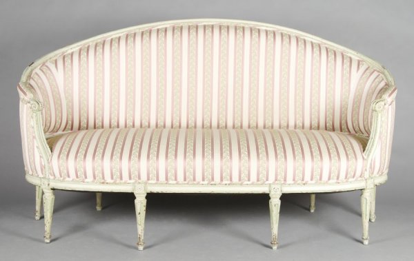 A Louis XVI Style Painted Canape, Width 70 1/2 inches.: A Louis XVI Style Painted Canape, the rounded frame over upholstered back, arms and seats, the tapering fluted legs surmounted with rosette decorated joints. Width 70 1/2 inches.