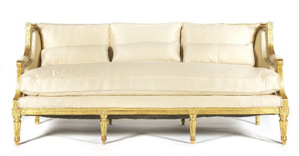 A Louis XVI Style Canape, Length 75 inches.: A Louis XVI Style Canape, having upholstered back, arms and seat set within a rosette carved frame raised on fluted tapering legs. Length 75 inches.