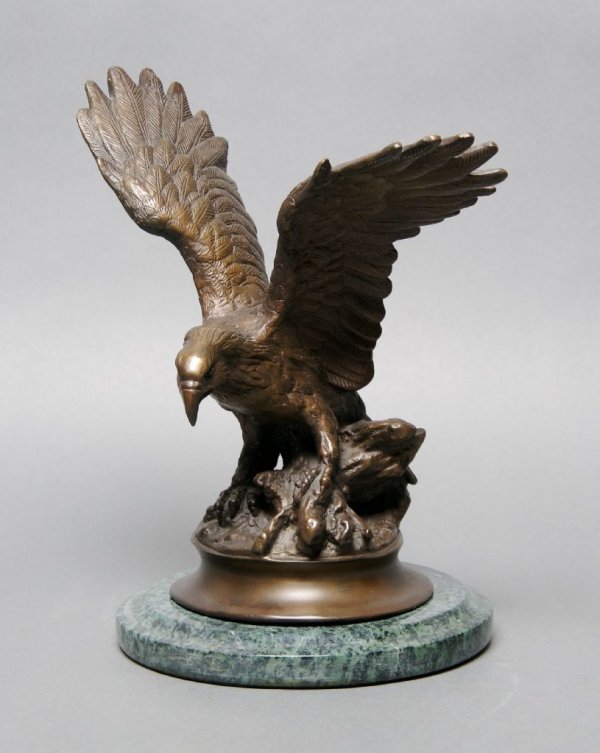 A Bronze Figure of an Eagle, Jules Moignez, Height 10 1: A Bronze Figure of an Eagle, Jules Moignez, depicted with outstretched wings and perched atop a branch, signed on base, the whole raised on a green veined marble base. Height 10 1/2 inches.