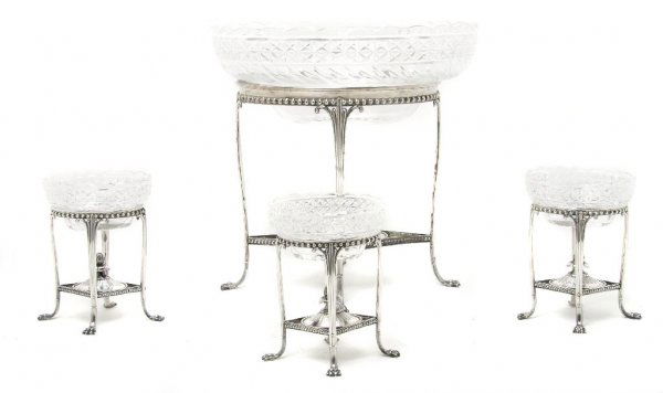 A Set of Four Silverplate and Cut Glass Epergnes, Heigh: A Set of Four Silverplate and Cut Glass Epergnes, each with oval glass bowl suspended on four legs joined by stretchers centered with a finial, comprising one central epergne and three smaller example