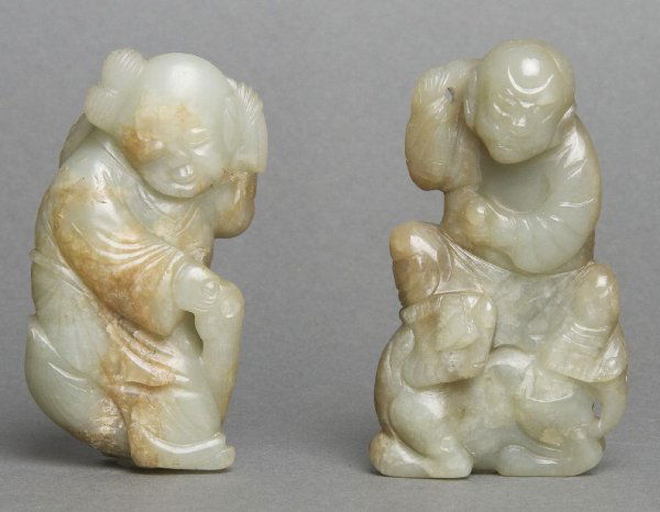 A Celadon Jade Carving of a Boy, Height 3 inches.: A Celadon Jade Carving of a Boy, the youth depicted feeding a goose out of his hand, the stone having natural brown inclusion throughout, possibly Ming Dynasty, together with a later similar example o