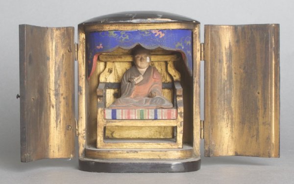 A Buddhist Traveling Shrine, Height 5 1/4 x width 4 1/8: A Buddhist Traveling Shrine, of Japanese origin, the interior depicting a Buddhist monk in a seated pose atop a giltwood throne, having polychrome decoration. Height 5 1/4 x width 4 1/8 inches.