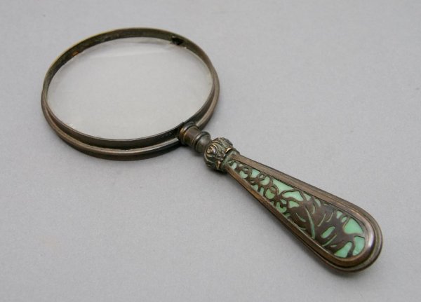 A Tiffany Studios Bronze and Glass Magnifying Glass, Le: A Tiffany Studios Bronze and Glass Magnifying Glass, of typical form, stamped Tiffany Studios 903. Length 8 1/4 inches.