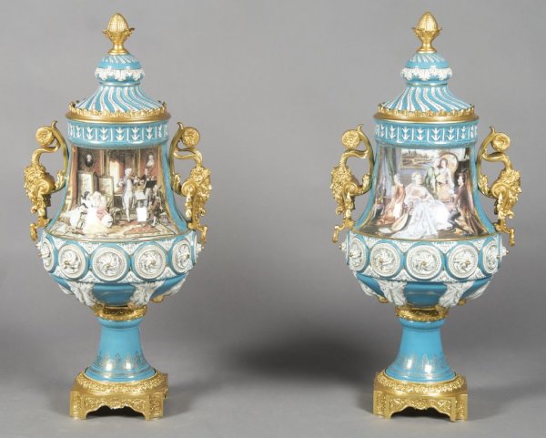 A Pair of Sevres Style Gilt Metal Mounted Urns, Dr: A Pair of Sevres Style Gilt Metal Mounted Urns, Dresden, 2nd half 20th century, each of baluster form with satyr mask handles, the porcelain painted with interior scenes, raised on square bases. Heigh