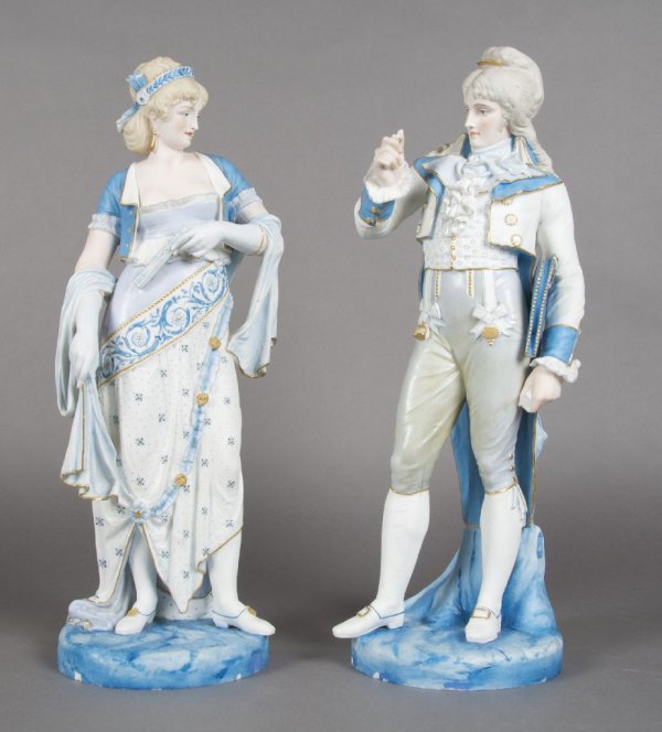 A Pair of French Bisque Porcelain Figures, Height: A Pair of French Bisque Porcelain Figures, depicting a man and a woman each with parcel gilt decoration raised upon a blue colored base, each marked on underside HA & Cie. Height 19 inches.
