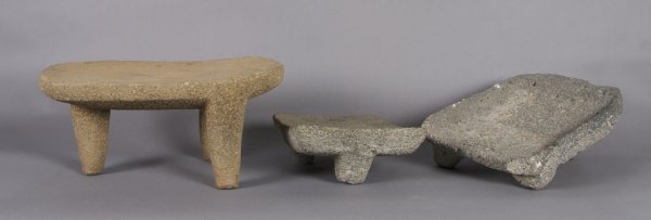 A Group of Three Costa Rican Stone Metate, Length : A Group of Three Costa Rican Stone Metate, two of grey volcanic stone and one of tan volcanic stone. Length of longest 20 1/2 inches.