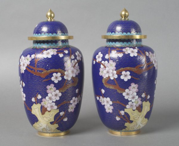 A Pair of Asian Cloisonne Ginger Jars, Height 9 1/: A Pair of Asian Cloisonne Ginger Jars, having lids with finials and floral decoration against a blue background. Height 9 1/2 inches.