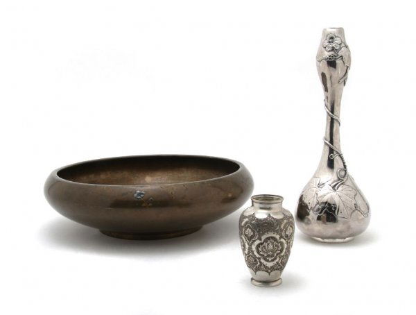 A Group of Three Asian Metal Work Objects, Height: A Group of Three Asian Metal Work Objects, a copper inlaid bowl for flower arranging, a silver garlic head bottle with wisteria decoration and a small silver baluster vase, each marked. Height of tall