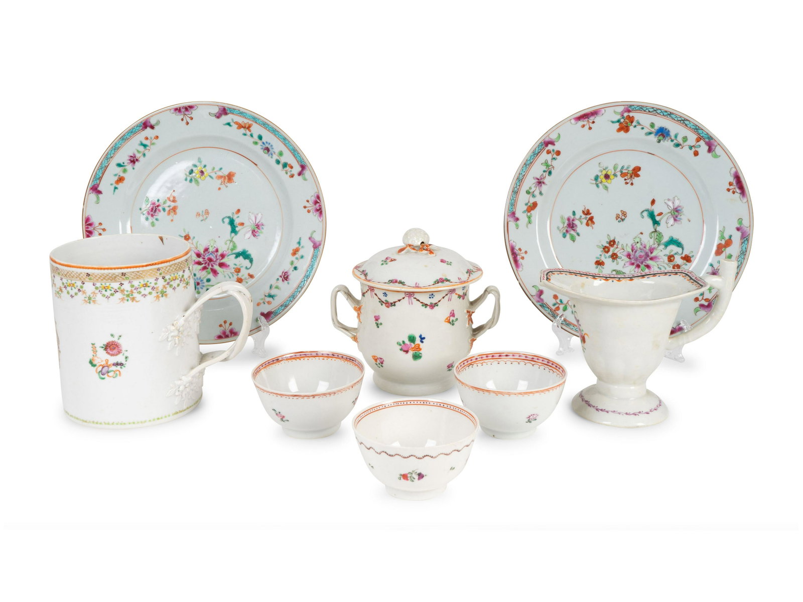 Eight Chinese Export Style Porcelain Table Articles: Eight Chinese Export Style Porcelain Table Articles comprising a pair of plates, three teabowls, a covered sugarbowl, a mug and a helmet-form cream pitcher. Diameter of plates 9 inches. The Estate of 