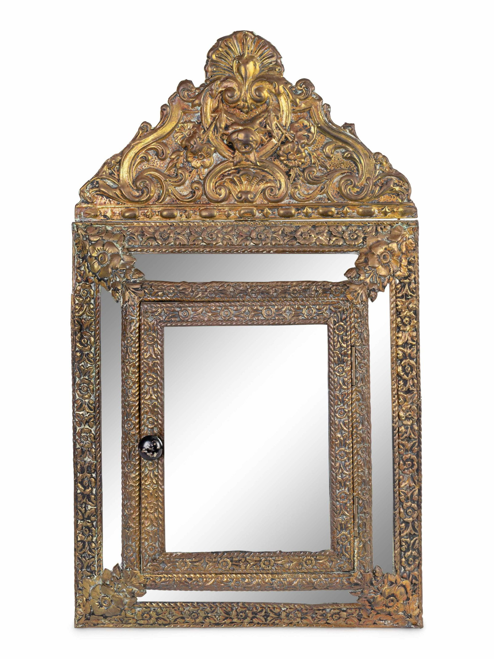 A Dutch Baroque Style Repoussed Brass Bride's: A Dutch Baroque Style Repoussed Brass Bride's Vanity Mirror 19TH CENTURY having a door enclosing two original brass mounted brushes. Height 25 3/4 x width 14 1/2 inches. Property from the Collec