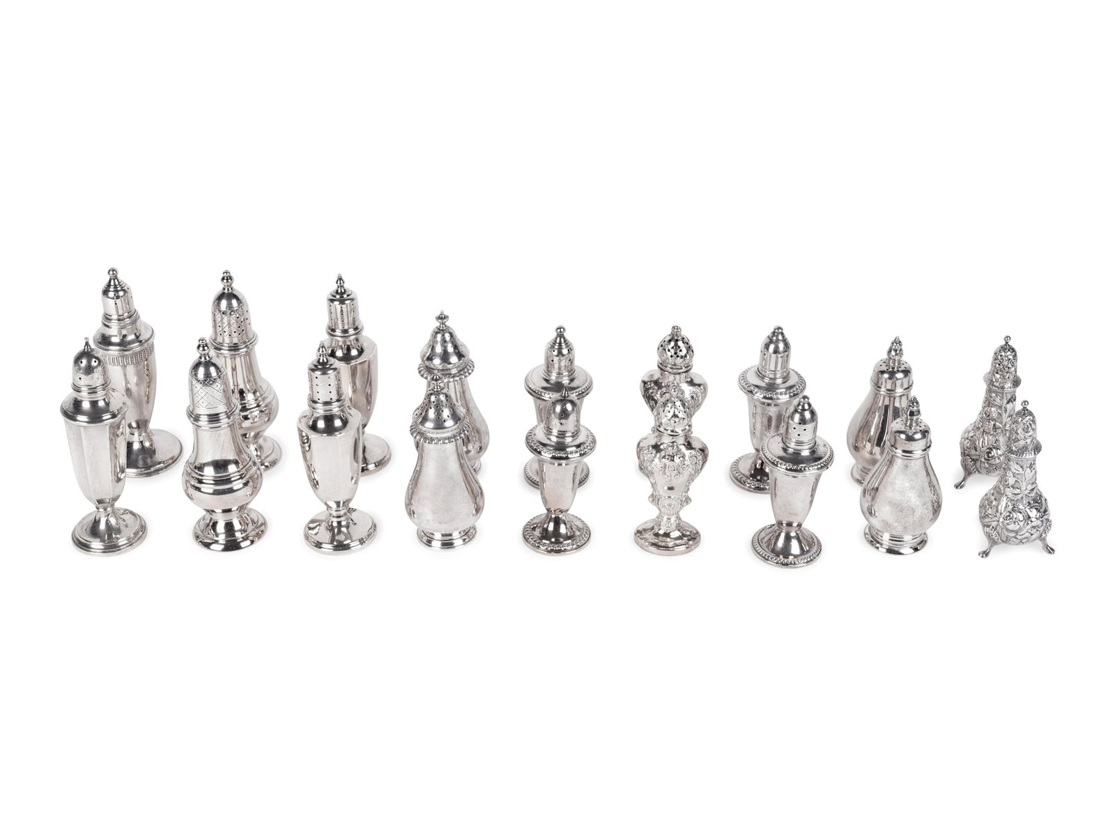 A Collection of Eighteen Silver Salt and Pepper Shakers: A Collection of Eighteen Silver Salt and Pepper Shakers comprising five silver pairs, three weighted silver pairs, and two odd weighted silver; by various makers. Height of tallest 6 inches.