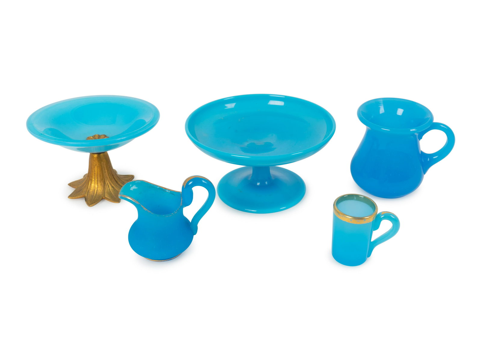 A Group of Five Parcel Gilt Blue Opaline Articles: A Group of Five Parcel Gilt Blue Opaline Articles comprising two tazzas, two cups and a cream jug. Height of largest 2 7/8 x diameter 5 1/4 inches.