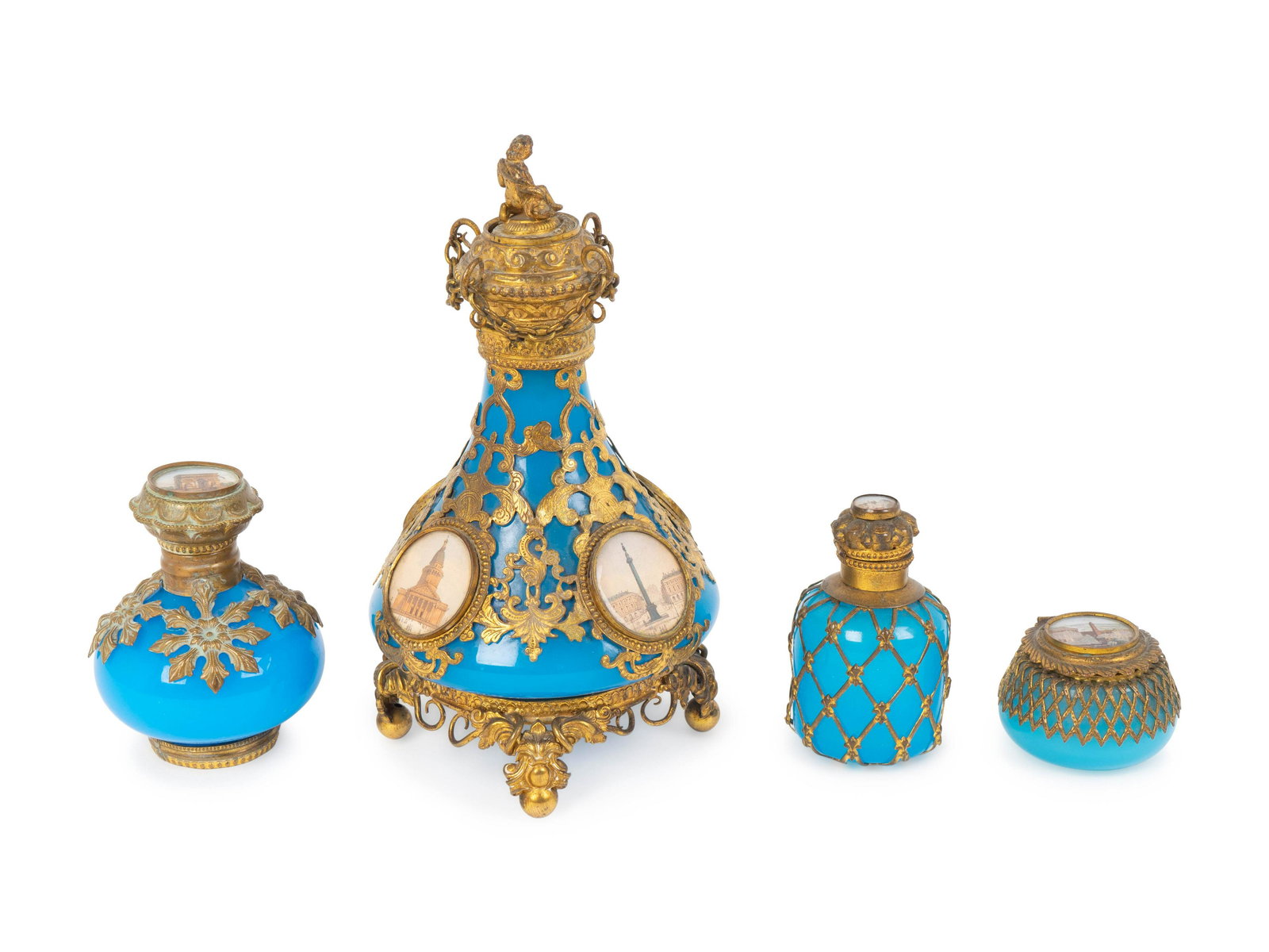 Three French Gilt Bronze Mounted Blue Opaline Glass: Three French Gilt Bronze Mounted Blue Opaline Glass Scent Bottles and a Covered Box comprising one with openwork gilt bronze decoration with four miniature roundels decorated with Paris landmarks, one