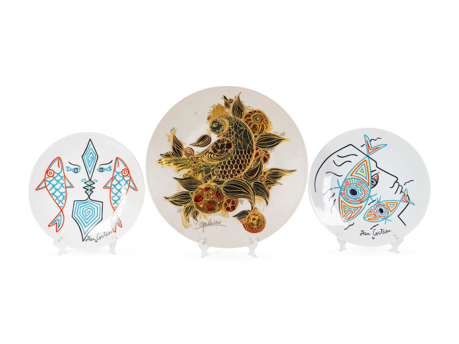 Two Jean Cocteau Plates and a Bjorn Winblad Charger: Two Jean Cocteau Plates and a Bjorn Winblad Charger (American, 1944-2014) Both Cocteau chargers decorated with two fish and a bust, Winblad charger decorated with a large gilt bird, the Cocteau charge