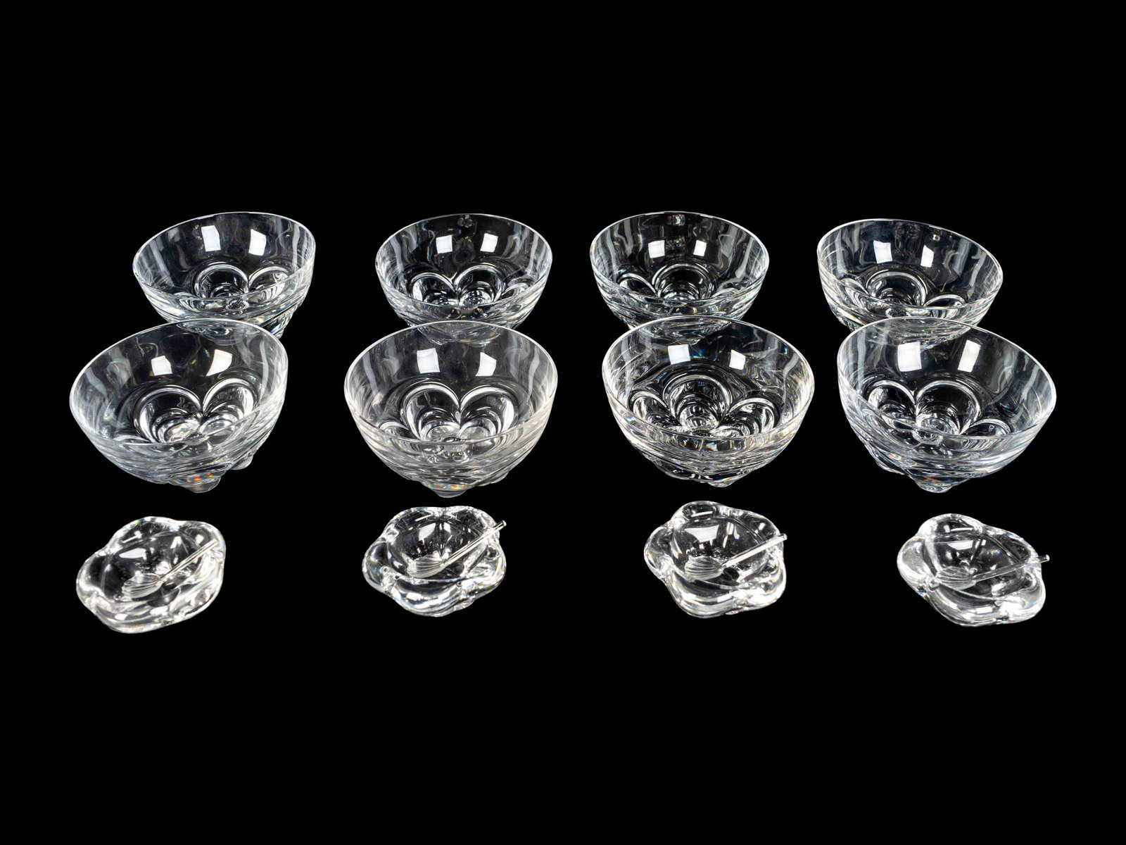 A Set of Eight Daum Fruit Bowls and Four Salts Height: A Set of Eight Daum Fruit Bowls and Four Salts Each circular bowl with petal-form base; inscribed Daum; the floriform salts inscribed Daum/France; the salts with two original boxes. Height of bowls 2 