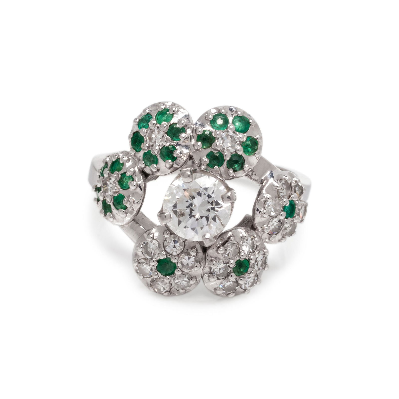 DIAMOND AND EMERALD RING: DIAMOND AND EMERALD RING Containing one round brilliant cut diamond weighing approximately 0.65 carat, 21 single cut diamonds and 21 round mixed cut emeralds. Mounted in white gold. Ring size 5 3/4. S