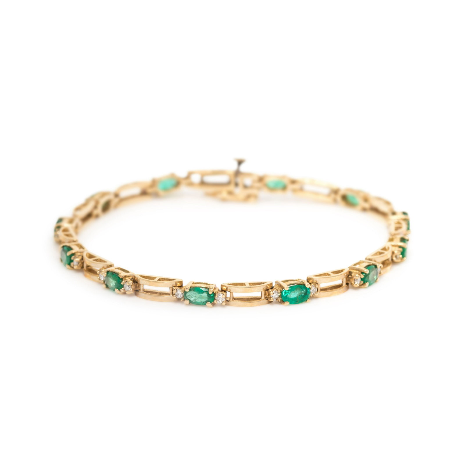 EMERALD AND DIAMOND BRACELET: EMERALD AND DIAMOND BRACELET Containing 12 oval mixed cut emeralds measuring approximately 5.00 x 3.00 mm and 24 round brilliant cut diamonds weighing approximately 0.30 carat total. Mounted in yellow
