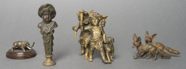A Collection of Metal Decorative Objects, Height of tal: A Collection of Metal Decorative Objects, comprising a figural term, a group of foxes, a chariot and two children with dog hunting. Height of tallest 3 3/4 inches.