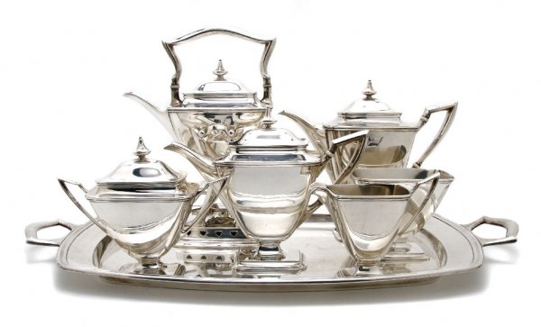 An American Seven Piece Sterling Silver Tea Servic: An American Seven Piece Sterling Silver Tea Service, Towle, having faceted form, comprised of a teapot, coffee pot, creamer, lidded sugar, hot water kettle on stand with burner, waste bowl and tray, a