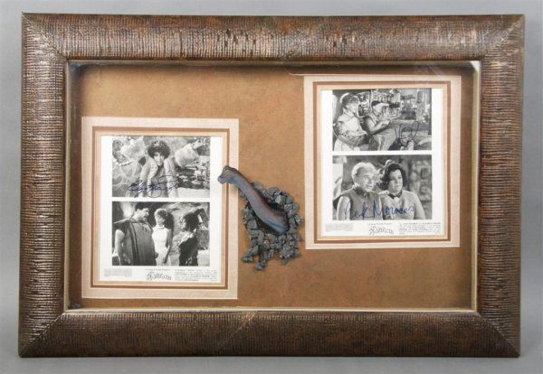 TAYLOR, ELIZABETH Size of frame 21 x 31 inches: TAYLOR, ELIZABETH Signed studio photo from The Flintstones. Framed together with three other studio photographs from the movie, two of which are signed by Rick Moranis and John Goodman. Elaborately fr