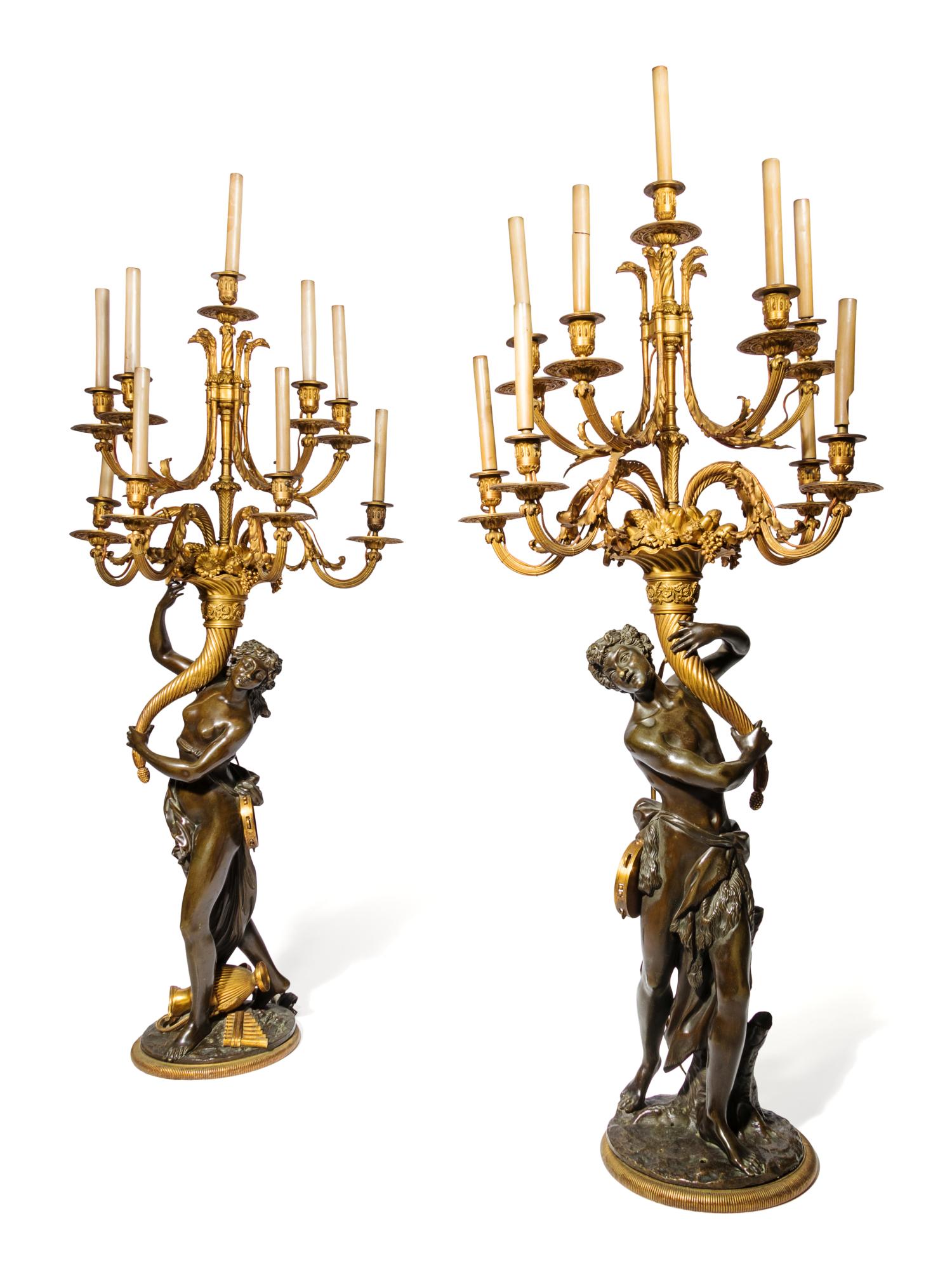 A Pair of Large Gilt and Patinated Bronze Figural: A Pair of Large Gilt and Patinated Bronze Figural Nine-Light Candelabra after the Models by Clodion 19th Century apparently unmarked. Height overall 58 inches. Property from Lawry's The Prime Rib, loc
