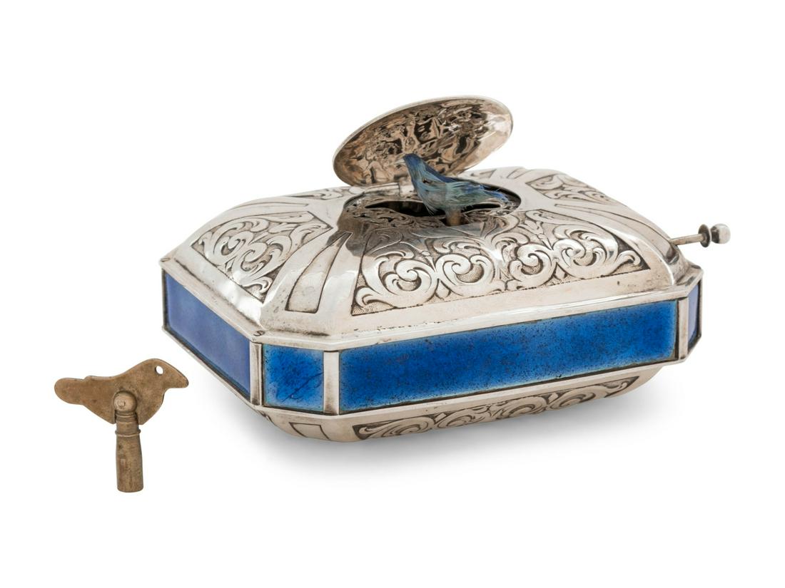 A German Silver and Enamel Singing Bird Automaton Box: A German Silver and Enamel Singing Bird Automaton Box Last Quarter 19th Century stamped .800 with reichsmark and crowned fleur-de-lis Hanau silver pseudo-mark Height 2 x width 4 1/2 x depth 3 3/8 inch
