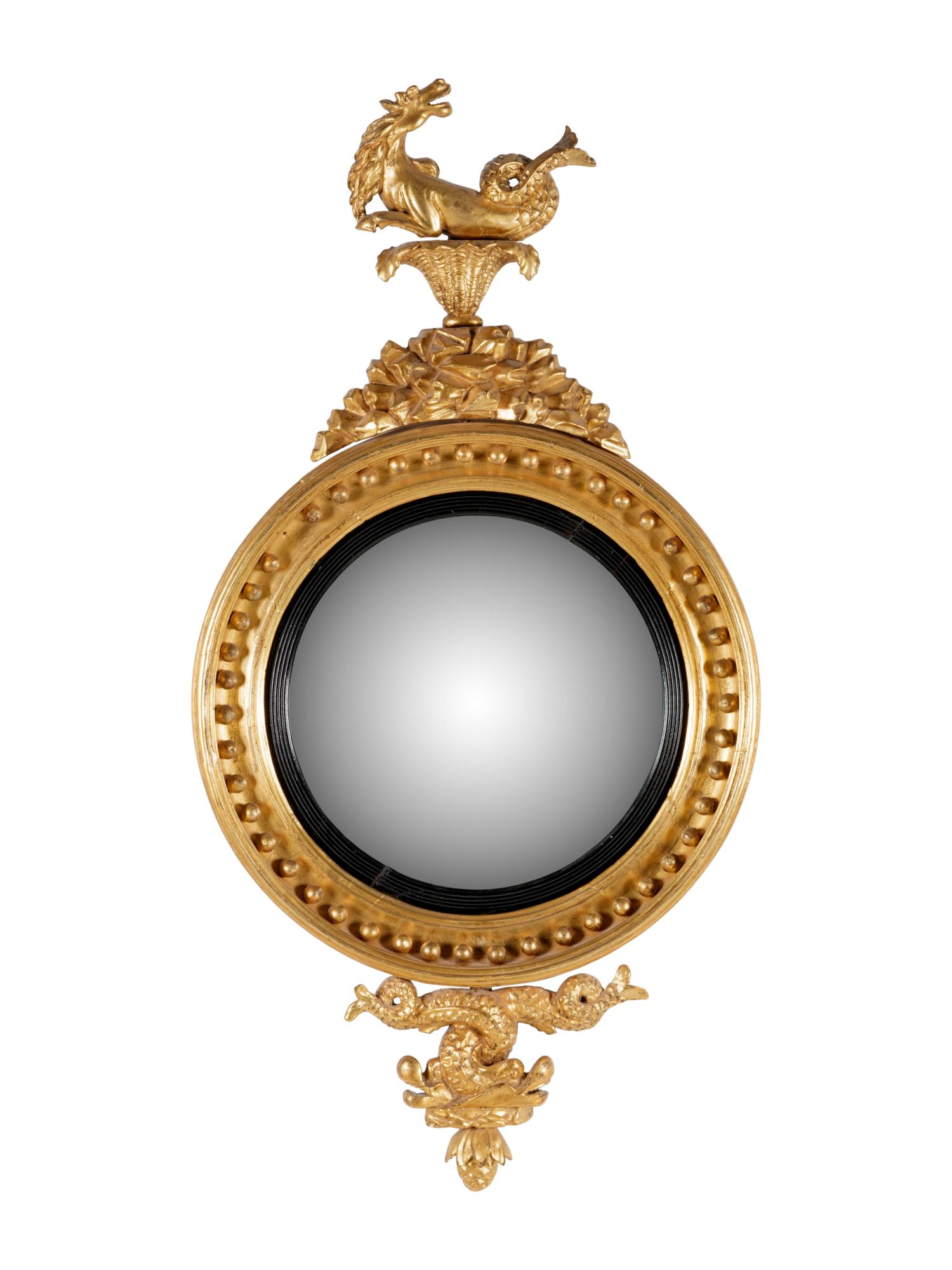 A George III Carved Giltwood Sea Dragon Bull's Eye: A George III Carved Giltwood Sea Dragon Bull's Eye Mirror 19th Century Height 42 x width 21 3/4 inches. Property from the Collection of Mary Southworth, Lake Forest, Illinois