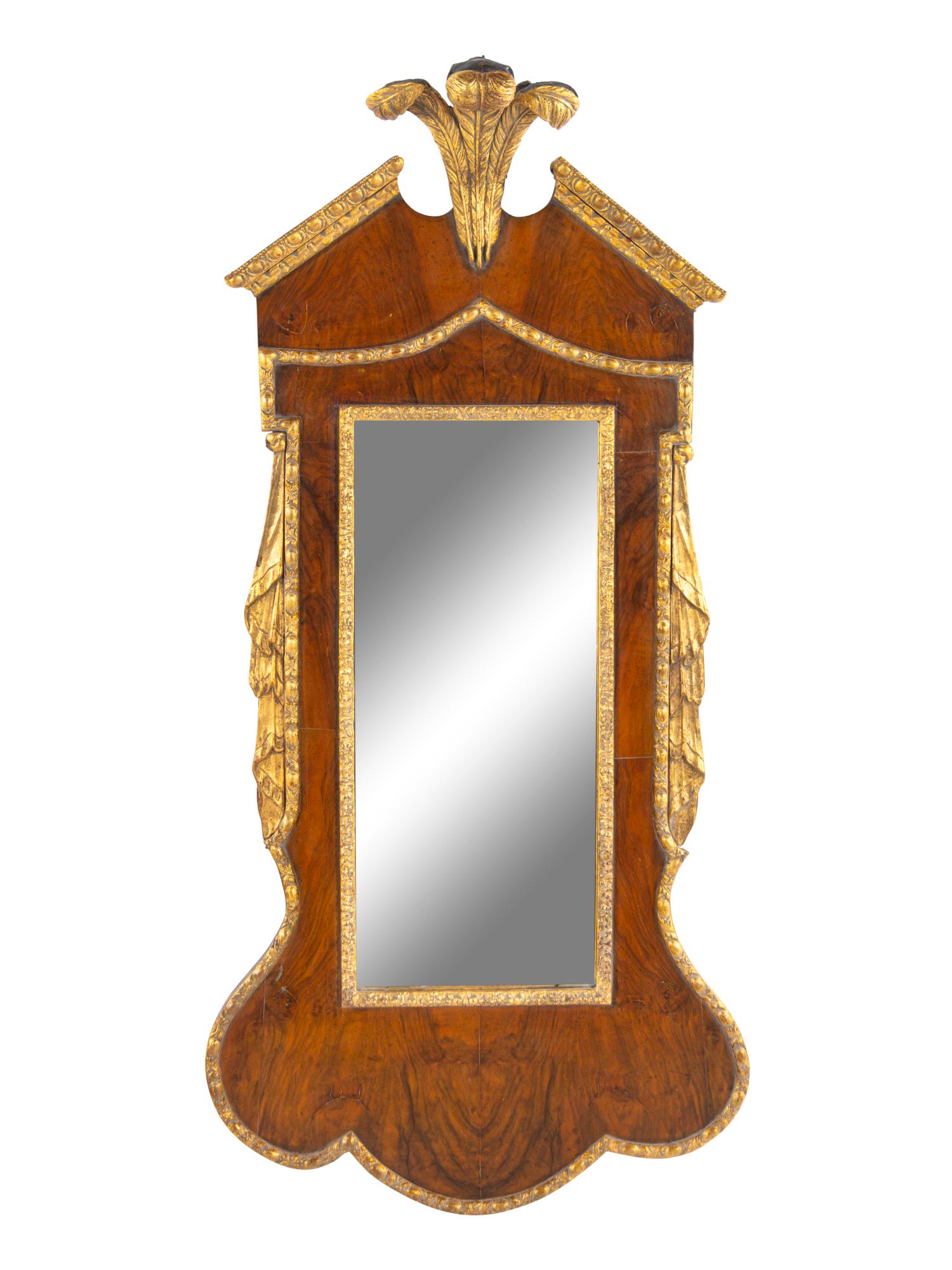 A George III Style Carved and Parcel Gilt Mahogany: A George III Style Carved and Parcel Gilt Mahogany Prince of Wales Feather Decorated Mirror 20th Century with Earlier Elements Height 52 1/2 inches. Property from the Collection of Mary Southworth, La