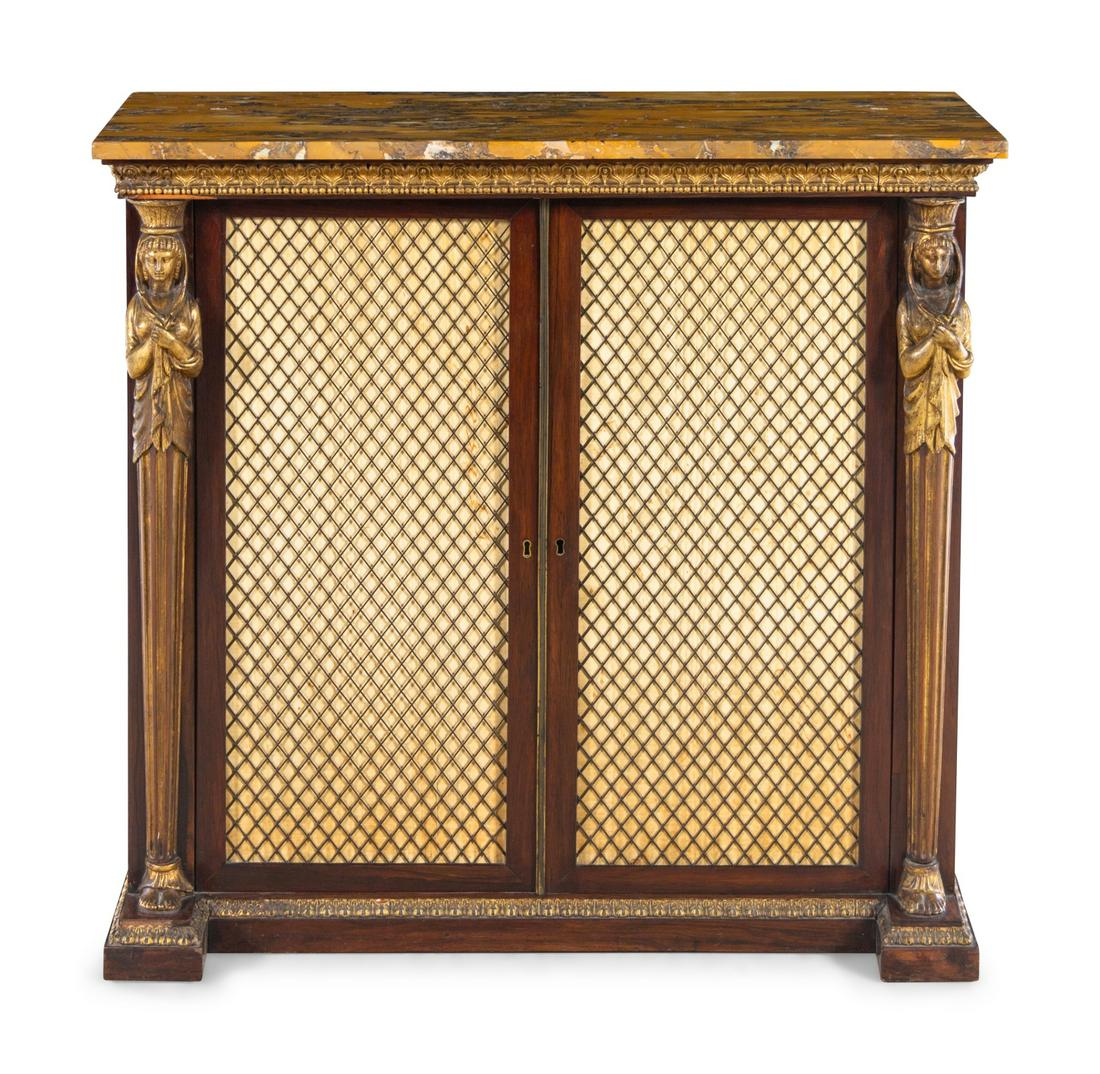 A Regency Egyptian Revival Style Parcel Gilt Rosewood: A Regency Egyptian Revival Style Parcel Gilt Rosewood Cabinet 19th Century Height 36 x width 38 x depth 14 inches.