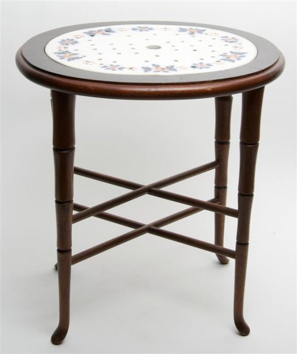 An English Pottery Trivet, Width of first 12 1/4 inches: An English Pottery Trivet, of oval, pierced form, set on a fitted stand, together with a Royal Copenhagen charger on an associated table. Width of first 12 1/4 inches.