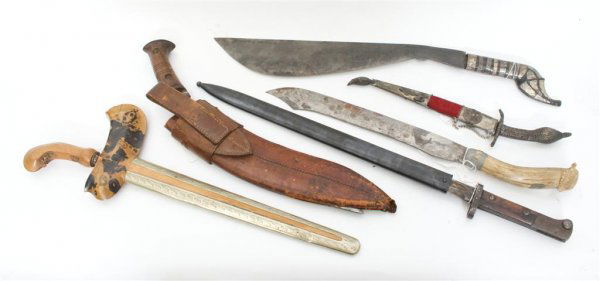 A Collection of Bladed Weapons, Length of longest 23 in: A Collection of Bladed Weapons, comprising two kris, two small machetes, a bayonet and a bone handled knife. Length of longest 23 inches.
