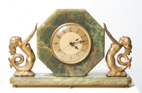 An Art Deco Style Green Onyx Mantle Clock, Whitehall Ha: An Art Deco Style Green Onyx Mantle Clock, Whitehall Hammond, of octagonal form, raised on a rectangular base, the 5 1/2 inch gilt dial having Arabic numerals and flanked by mermaid form figures, fitt