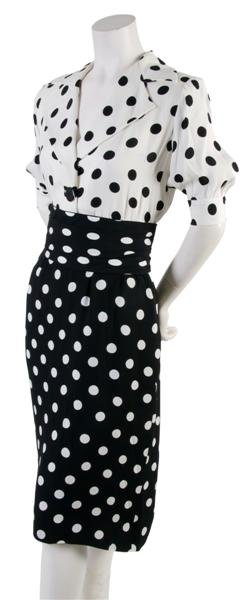 An Yves Saint Laurent Black and White Polka Dot Dr: An Yves Saint Laurent Black and White Polka Dot Dress, with puff sleeves, a notched collar cummerbund at waist, on seam pockets. Labeled: Saint Laurent.