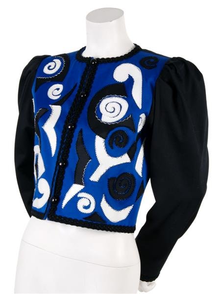 An Yves Saint Laurent Blue, Black and White Bolero: An Yves Saint Laurent Blue, Black and White Bolero, 1980s, with geometric appliques at front, braided trim, fully lined. Labeled:Saint Laurent. Size 40.