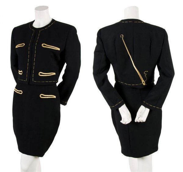 A Moschino Couture Black 'Sewing' Skirt Suit, Size: A Moschino Couture Black 'Sewing' Skirt Suit, jacket with gold 'thread' trim, exaggerated gold embroidered button holes at front with a gold needle at back, pencil skirt. Labeled on skirt: Moschino Co