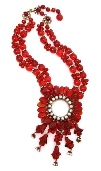 A Miriam Haskell Red Glass Necklace,: A Miriam Haskell Red Glass Necklace, with a circular floral like pendant with rhinestones and dangling attachments, signature clasp. Stamped: Miriam Haskell.