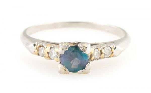 A Platinum, Alexandrite and Diamond Ring, 2.06 dwts.: A Platinum, Alexandrite and Diamond Ring, containing one round brilliant cut alexandrite weighing approximately 0.40 carat and four small single cut and full cut diamonds. 2.06 dwts.