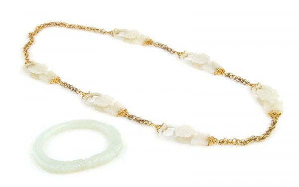 A Group of Jade Jewelry, 34.25 dwts.: A Group of Jade Jewelry, comprising a light green jade bangle with organic carved detail and a gold filled link and light green jade necklace. 34.25 dwts.
