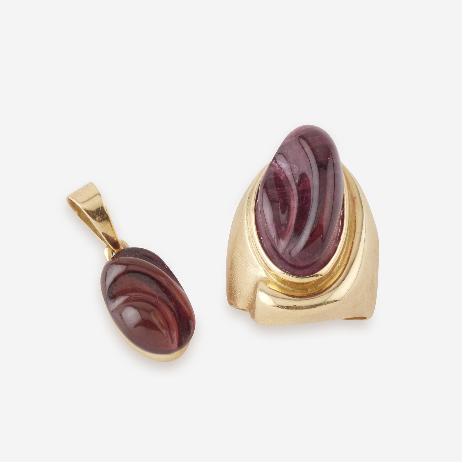 A carved tourmaline and eighteen karat gold pendant: A carved tourmaline and eighteen karat gold pendant with matching ring, Burle Marx and Bruno Guidi the pendant centering a carved pink tourmaline measuring approximately 15.9mm x 10.1mm x 9.0mm, the b