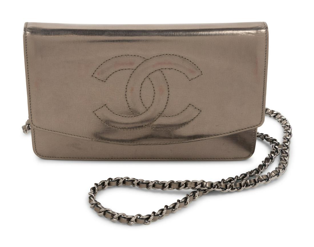 Chanel Metallic Leather Wallet Bag, 2008-2009: Chanel Metallic Leather Wallet Bag, 2008-2009 Metallic dark gold leather flap wallet bag with Ruthenium-tone and leather braided chain shoulder strap and front snap closure. Label (stamped): Chanel St