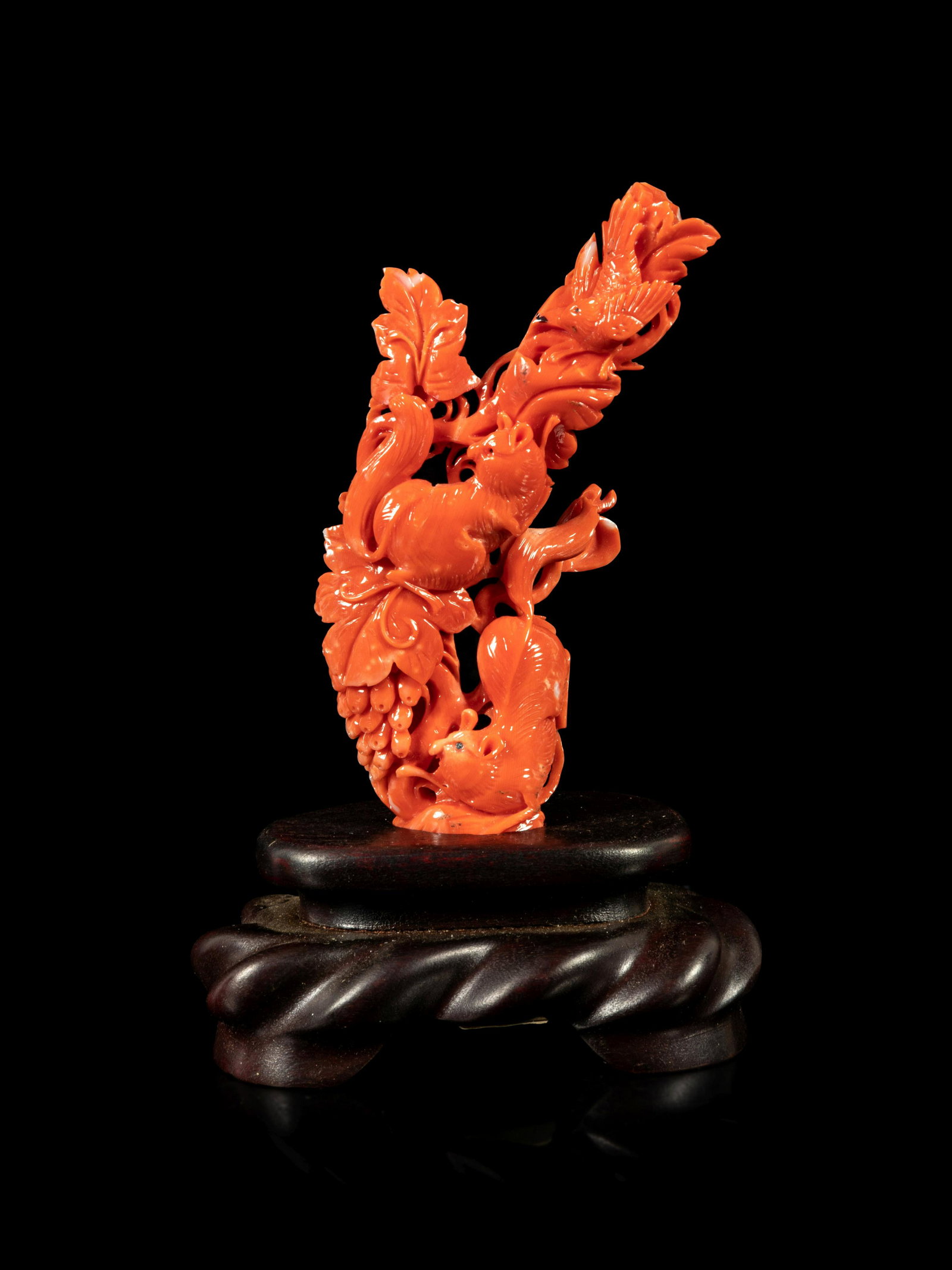 A Red Coral Carving of Squirrels and Grapes: A Red Coral Carving of Squirrels and Grapes EARLY-MID 20TH CENTURY 近代 紅珊瑚松鼠葡萄擺件 depicting squirrels scrambling amongst frui
