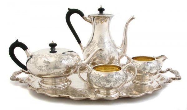 An American Sterling Silver Tea and Coffee Service: An American Sterling Silver Tea and Coffee Service, Birks, comprising teapot, coffee pot, creamer, open sugar, and tray, the tea and coffee pot each with ebonized wood handles and finial, approximate 