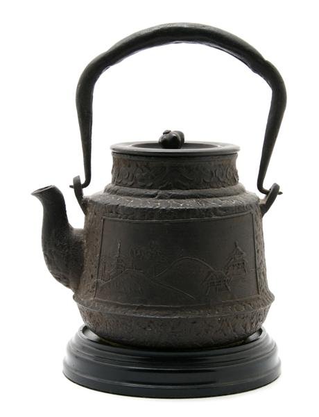 A Japanese Iron Teapot, Height 8 inches.: A Japanese Iron Teapot, having foliate knob with panels depicting landscape scenes. Height 8 inches. Patricia J. Gottschalk Trust, Northfield, Illinois